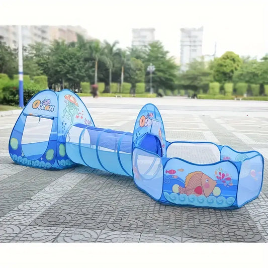 Children's play set with blue tunnel and ocean-themed design on a pavement.